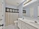 Bathroom features double sinks, light blue walls and tiled floors at 6625 Eagle Pt, Suwanee, GA 30024
