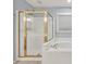 Bathroom with gold-trimmed shower and soaking tub featuring white tile at 6625 Eagle Pt, Suwanee, GA 30024