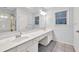 Bright bathroom featuring double sinks, tiled floors, shower and separate soaking tub at 6625 Eagle Pt, Suwanee, GA 30024