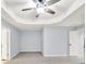 Bedroom with tray ceiling, carpet and a ceiling fan at 6625 Eagle Pt, Suwanee, GA 30024