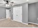Neutral bedroom features include carpet floors, ceiling fan, and white closet doors at 6625 Eagle Pt, Suwanee, GA 30024