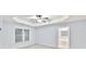 Bedroom with ceiling fan and view to a bright ensuite bathroom with large window at 6625 Eagle Pt, Suwanee, GA 30024