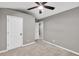 Neutral bedroom features include carpet floors, ceiling fan, and white doors at 6625 Eagle Pt, Suwanee, GA 30024