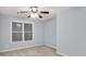 Bedroom features carpet, a ceiling fan, and a large window at 6625 Eagle Pt, Suwanee, GA 30024