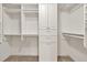 Walk-in closet featuring built-in shelving and ample storage space at 6625 Eagle Pt, Suwanee, GA 30024