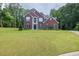 Beautiful brick home with a well-maintained lawn and a lush, green tree backdrop at 6625 Eagle Pt, Suwanee, GA 30024