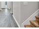 Hallway with hardwood-style flooring and neutral paint, leading to the front door at 6625 Eagle Pt, Suwanee, GA 30024