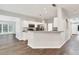 Open kitchen featuring white cabinets, stainless steel appliances, and an eat-in bar at 6625 Eagle Pt, Suwanee, GA 30024