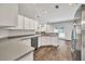 Well-lit kitchen with stainless steel dishwasher and sink with views into the main living area at 6625 Eagle Pt, Suwanee, GA 30024