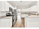 Bright kitchen with white cabinets, stainless steel appliances, and ample counter space at 6625 Eagle Pt, Suwanee, GA 30024
