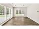 Sun room with lots of natural light, neutral walls and wood-look floors, great for relaxing at 6625 Eagle Pt, Suwanee, GA 30024