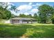 Large backyard with covered porch, patio, and lush green grass at 1305 Clay Sw Rd, Mableton, GA 30126