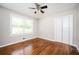 Bedroom with hardwood floors, ceiling fan, and natural light from a double window at 1305 Clay Sw Rd, Mableton, GA 30126