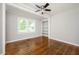 Bright bedroom featuring hardwood floors, ceiling fan, and natural light at 1305 Clay Sw Rd, Mableton, GA 30126