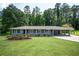 Charming home featuring a well-manicured front lawn and a covered carport, great curb appeal at 1305 Clay Sw Rd, Mableton, GA 30126