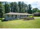 Charming single-story home featuring a well-manicured lawn and beautiful landscaping with a variety of flowers and greenery at 1305 Clay Sw Rd, Mableton, GA 30126