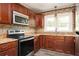 Well-equipped kitchen featuring stainless steel appliances, granite countertops, and tile backsplash at 1305 Clay Sw Rd, Mableton, GA 30126
