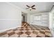 Bright sunroom featuring checkered tile flooring, built-in shelving, and access to the backyard at 1305 Clay Sw Rd, Mableton, GA 30126
