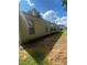 Tan home exterior with many windows and a grassy and dirt backyard at 2703 Hillvale Cove Dr, Lithonia, GA 30058