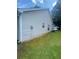 Exterior of a tan home featuring a grassy yard and well-maintained siding at 2703 Hillvale Cove Dr, Lithonia, GA 30058