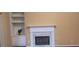 Built-in shelving flanks a marble fireplace with white trim at 2703 Hillvale Cove Dr, Lithonia, GA 30058