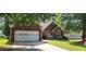 Charming single-story brick home with a well-maintained lawn and attached two-car garage at 2703 Hillvale Cove Dr, Lithonia, GA 30058
