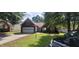 Charming single-story brick home with a well-maintained lawn, driveway and garage at 2703 Hillvale Cove Dr, Lithonia, GA 30058