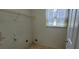 Functional laundry room features a wire rack for storage and a window for natural light at 2703 Hillvale Cove Dr, Lithonia, GA 30058