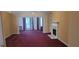 Bright living room showcasing fireplace, built-in shelving, and neutral-toned walls and carpet at 2703 Hillvale Cove Dr, Lithonia, GA 30058