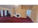 Spacious living room with fireplace, built-in shelving, and neutral-toned walls and carpet at 2703 Hillvale Cove Dr, Lithonia, GA 30058