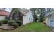 A well-maintained home exterior, green lawn, and some bushes next to house at 2703 Hillvale Cove Dr, Lithonia, GA 30058