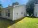 Exterior of a tan home featuring a grassy yard and well-maintained siding at 2703 Hillvale Cove Dr, Lithonia, GA 30058