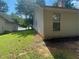 Exterior of a tan home with an AC unit and a large grassy yard at 2703 Hillvale Cove Dr, Lithonia, GA 30058