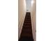A staircase with a white handrail and dark carpet at 2703 Hillvale Cove Dr, Lithonia, GA 30058