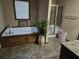 Relaxing bathroom with a soaking tub and separate glass-enclosed shower at 512 S Holly Springs Rd, Woodstock, GA 30188