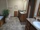Bathroom featuring dual vanities, ample counter space, and a relaxing tub at 512 S Holly Springs Rd, Woodstock, GA 30188
