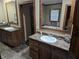 Well-appointed bathroom with dual vanities, wood cabinets, and a luxurious soaking tub at 512 S Holly Springs Rd, Woodstock, GA 30188