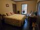 Charming bedroom with floral bedding, a window letting in natural light, and a vintage rocking chair at 512 S Holly Springs Rd, Woodstock, GA 30188