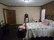 Bedroom with a large bed, dark wood accents, and an adjacent mirror at 512 S Holly Springs Rd, Woodstock, GA 30188