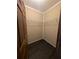 Spacious walk-in closet with wooden floors and open wire shelving for ample storage at 512 S Holly Springs Rd, Woodstock, GA 30188