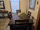 Cozy dining area with a wooden table set for four, complemented by natural light streaming through the window at 512 S Holly Springs Rd, Woodstock, GA 30188