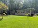 Charming home exterior with inviting front porch, well-maintained lawn, and mature trees at 512 S Holly Springs Rd, Woodstock, GA 30188