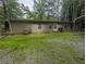 Home exterior featuring a back entry, a partial deck and a gravel and grass yard at 512 S Holly Springs Rd, Woodstock, GA 30188