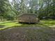 Charming single-story home with a welcoming porch and a convenient carport nestled in a lush, wooded landscape at 512 S Holly Springs Rd, Woodstock, GA 30188