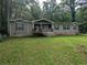 Charming single-story home with a inviting front porch, complemented by a large front yard surrounded by mature trees at 512 S Holly Springs Rd, Woodstock, GA 30188