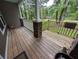 Covered front porch with stone accents and white railings, providing a perfect spot to sit and relax at 512 S Holly Springs Rd, Woodstock, GA 30188