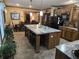 Spacious kitchen with a large island featuring seating, granite countertops, and tile flooring at 512 S Holly Springs Rd, Woodstock, GA 30188