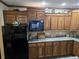 Kitchen area featuring wooden cabinets, modern appliances, stone countertops, and stylish decor at 512 S Holly Springs Rd, Woodstock, GA 30188