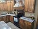 Well-appointed kitchen with ample wooden cabinets, stone countertops, stainless steel appliances, and a decorative range hood at 512 S Holly Springs Rd, Woodstock, GA 30188