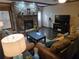 Comfortable living room area with stone fireplace, perfect for relaxing and entertaining at 512 S Holly Springs Rd, Woodstock, GA 30188